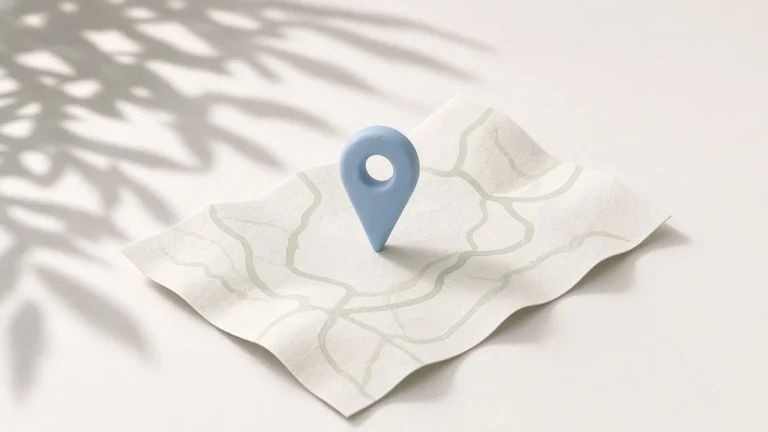 Claude Code settings.json location: a soft blue map pin standing on a folded pale paper map